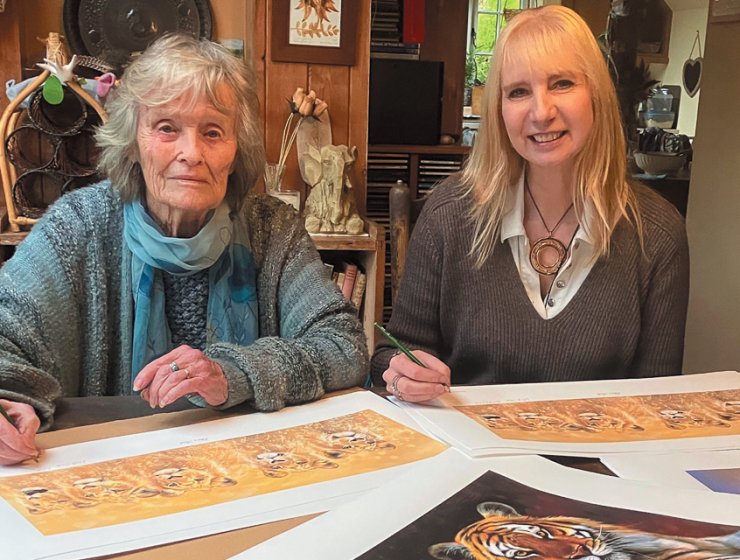 Anna-Louise Pickering and Virginia McKenna co-sign prints for the June exhibition.