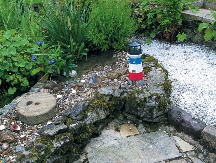 A lighthouse is this corner of a Middleton-by-Wirksworth garden.
