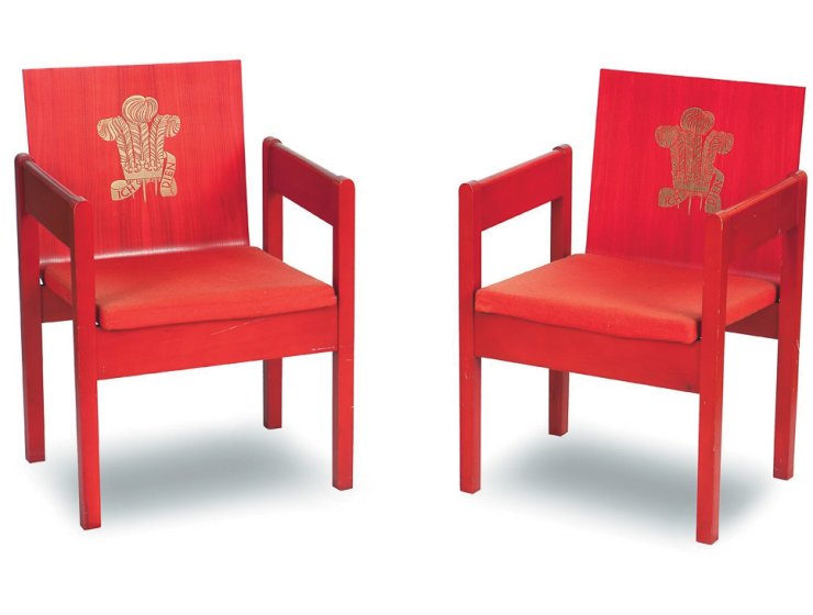 Two from a set of four Prince of Wales Investiture armchairs. The red plywood has upholstered seats and the Prince of Wales feathers embossed in gold to the backs. Designed by Lord Snowdon for the ceremony at Caernarvon Castle in 1969 and made by disabled workers at the Remploy factory in Bridgend, they made £2,860 in a recent specialist auction.