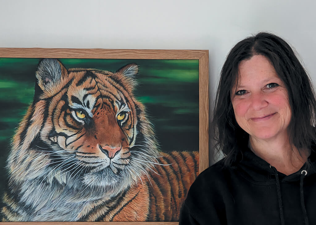 Frances Daunt with her painting of a tiger.