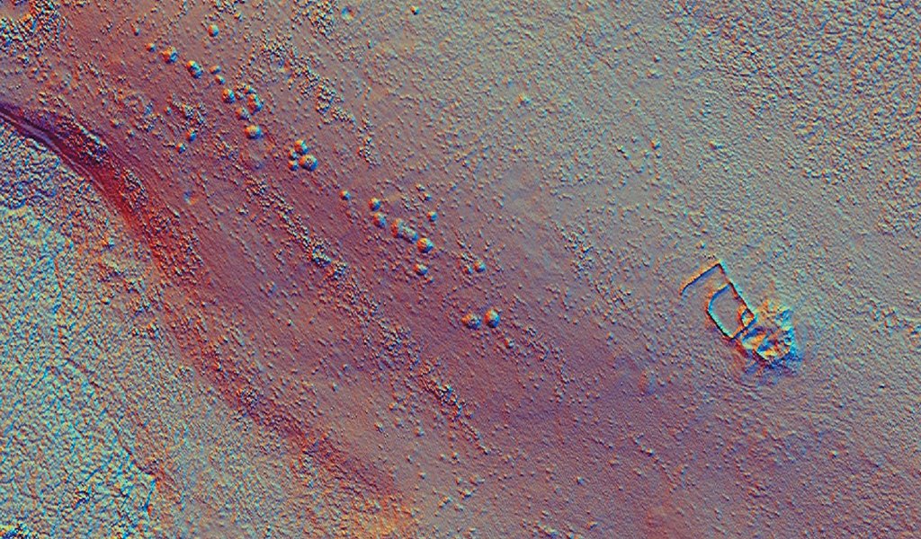 A LiDAR image (laser imaging, detection, and ranging) showing a line of cairns, in the middle of the image) that are hidden by bracken on the Peak District moors. The traditional way of finding and mapping these features would be a walked survey but it’s very time consuming and difficult to achieve amongst all of the vegetation. This survey located more features than had been previously identified because of the innovative methodology employed.