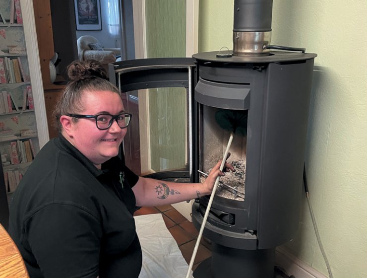 Rhiannon Hammond-Wright cleaning a stove.