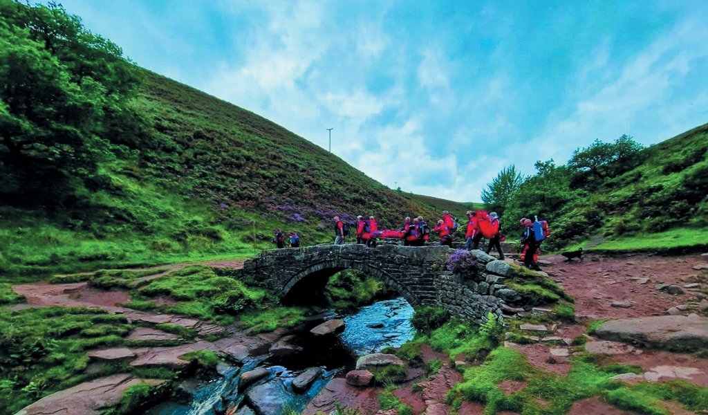 Bringing a casualty off a stretch of Peak District moorland.