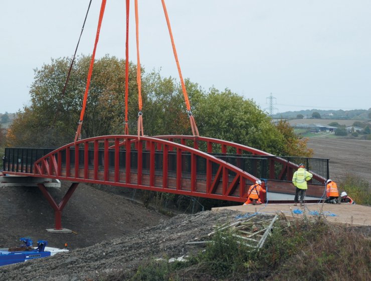 A crane lifts the new bridge into position at Staveley.