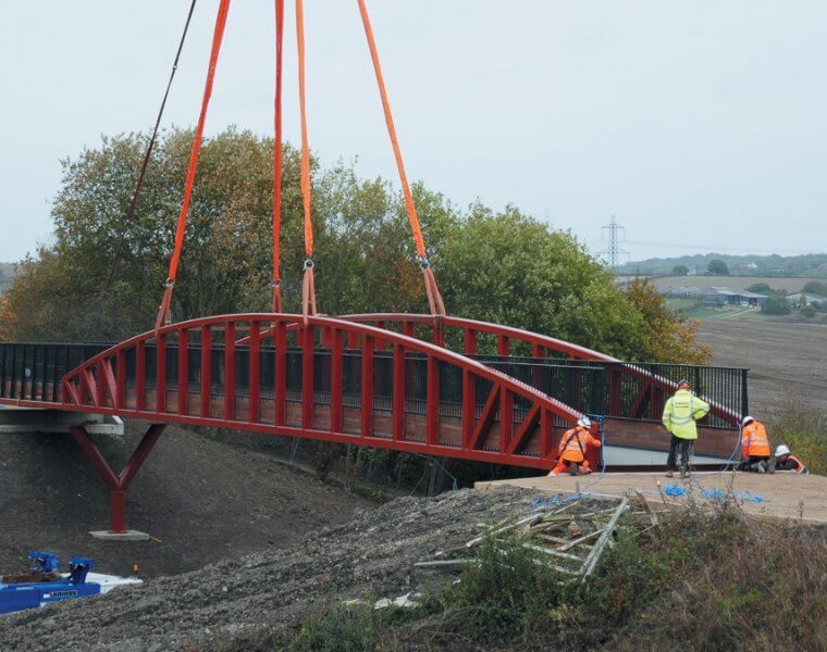 A crane lifts the new bridge into position at Staveley.