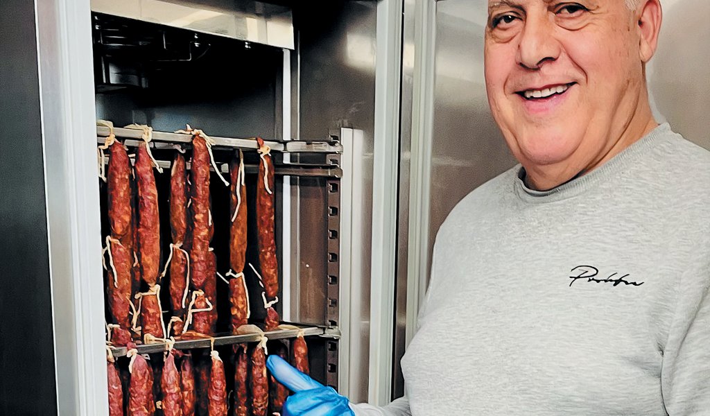 Felix checks the chorizo in one of the cabinets.