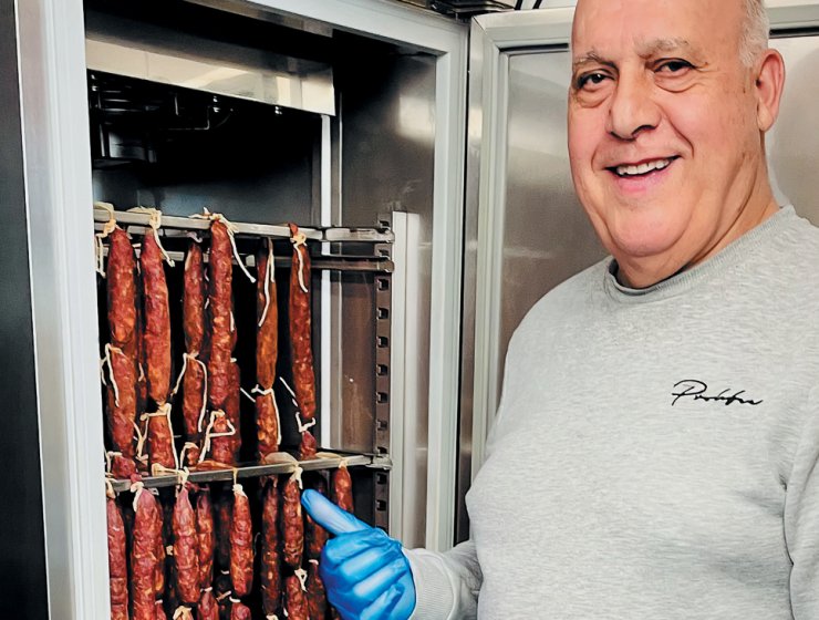 Felix checks the chorizo in one of the cabinets.