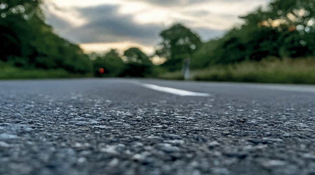 Tarmac Road under grey clouds