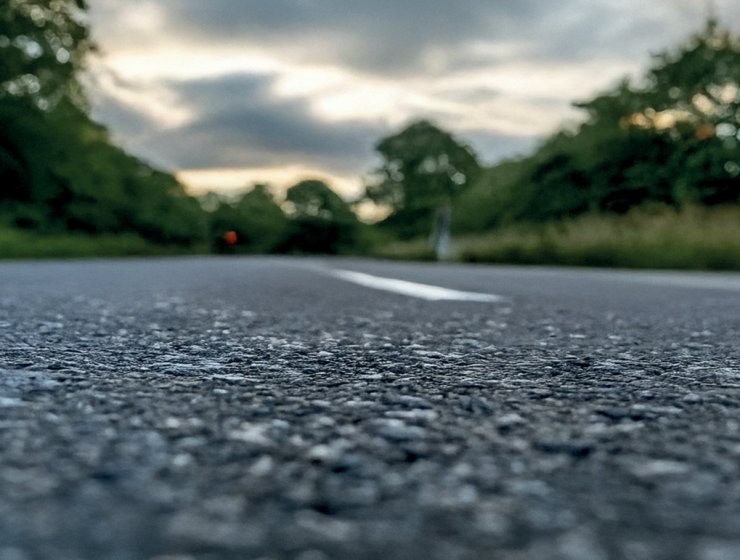 Tarmac Road under grey clouds