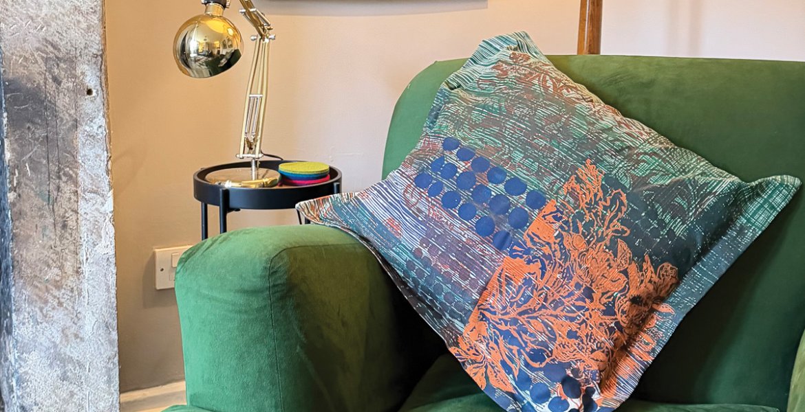 One of Sara’s designs adorns a cushion in the sitting room of her Peak District cottage