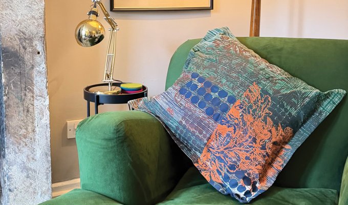 One of Sara’s designs adorns a cushion in the sitting room of her Peak District cottage