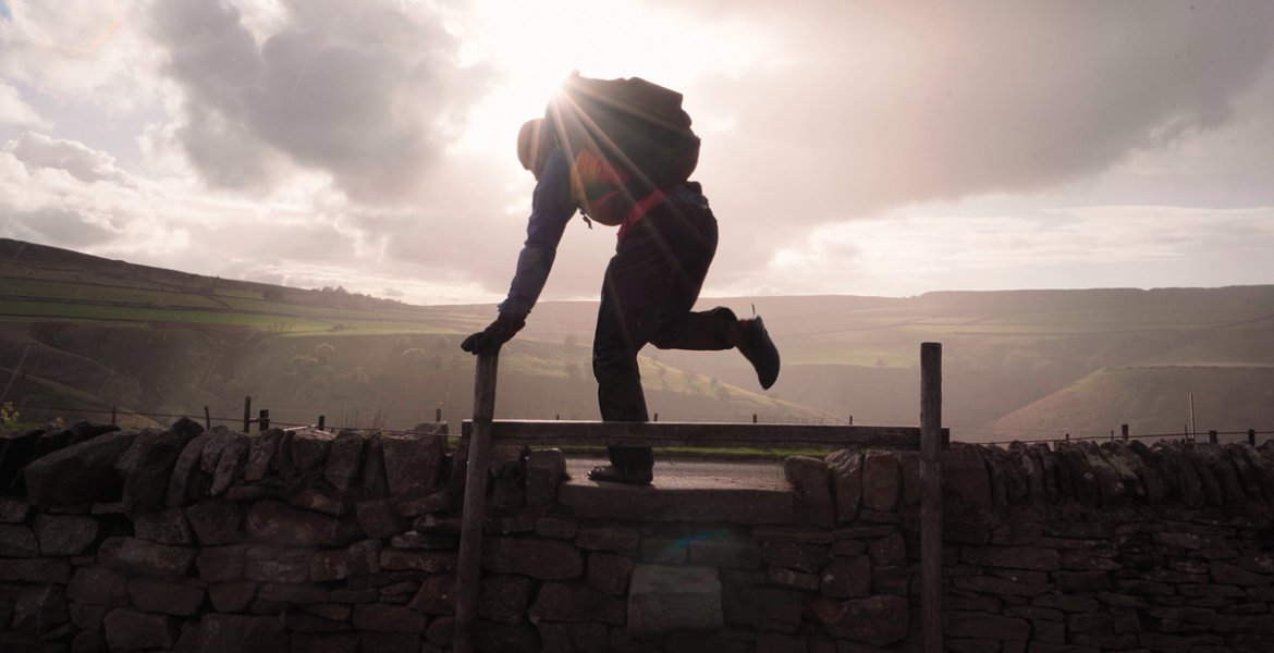 Into the sunlight as Ben scales a stile