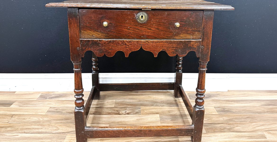 This George I (Reign 1714-1727) oak and ash side table, c.1720, measuring 74cm wide, made £850 in a recent traditional antique auction. Consigned from a deceased estate near Bakewell, the result is considered to be a good price in the current market, showing the continued demand for authentic antique pieces in original condition.