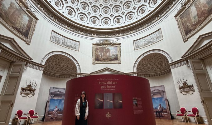 Paige with part of the exhibition, How Did We Get Here?