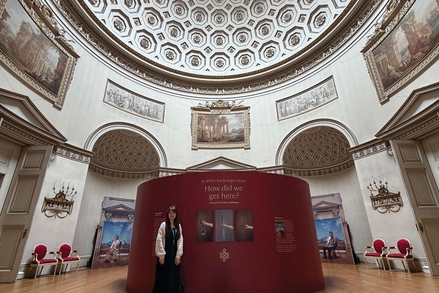 Paige with part of the exhibition, How Did We Get Here?