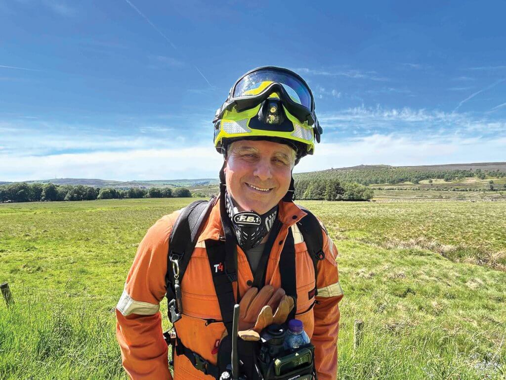 Danny Udall, site manager for Eastern Moors Partnership, walked in full wildfire fighting kit