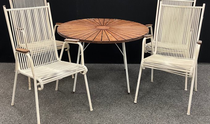 The late 20th century Daneline teak and white tubular metal circular garden table, 99.5cm diameter, with four famous “Spaghetti” chairs. The composite suite was saved from the skip and made £250 in a recent auction